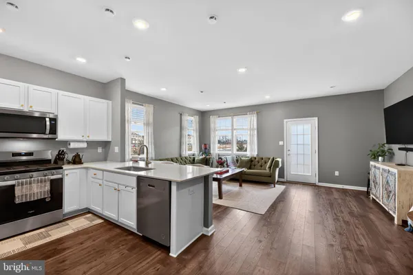 a view of kitchen with sink microwave and stove