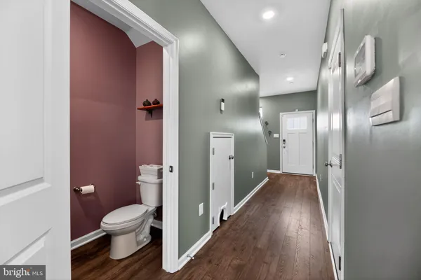 a bathroom with a toilet and a glass door
