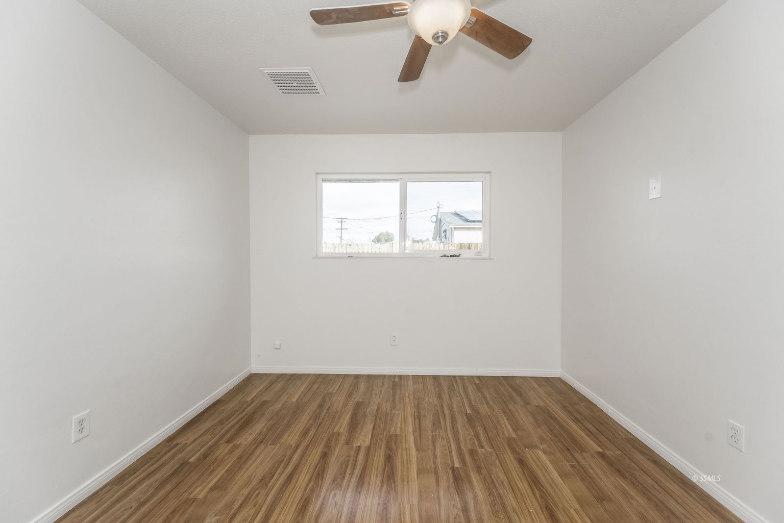 412 East Church Avenue Ridgecrest, CA 93555 - Photo 20 of 39 an empty room with a window and wooden floor
