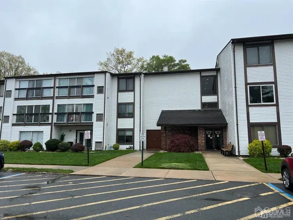 a front view of a house with a garden and plants