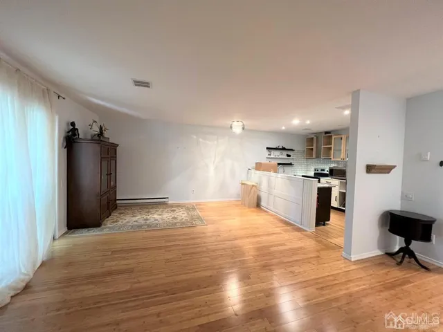 a view of kitchen with refrigerator microwave and wooden floor