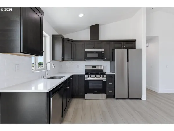a kitchen with refrigerator cabinets and stainless steel appliances