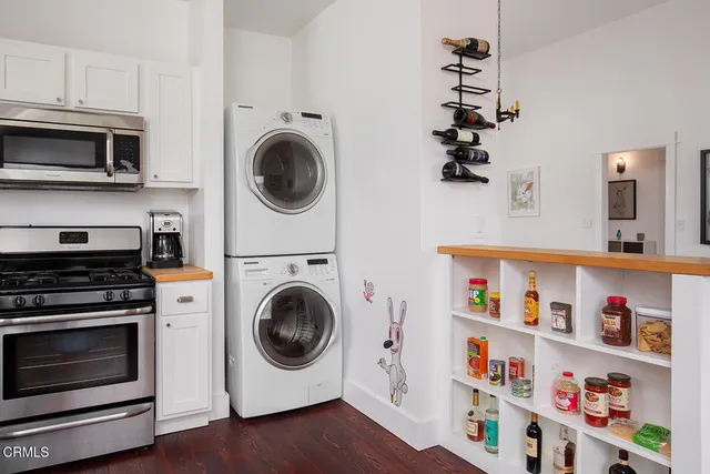 a utility room with sink dryer and washer
