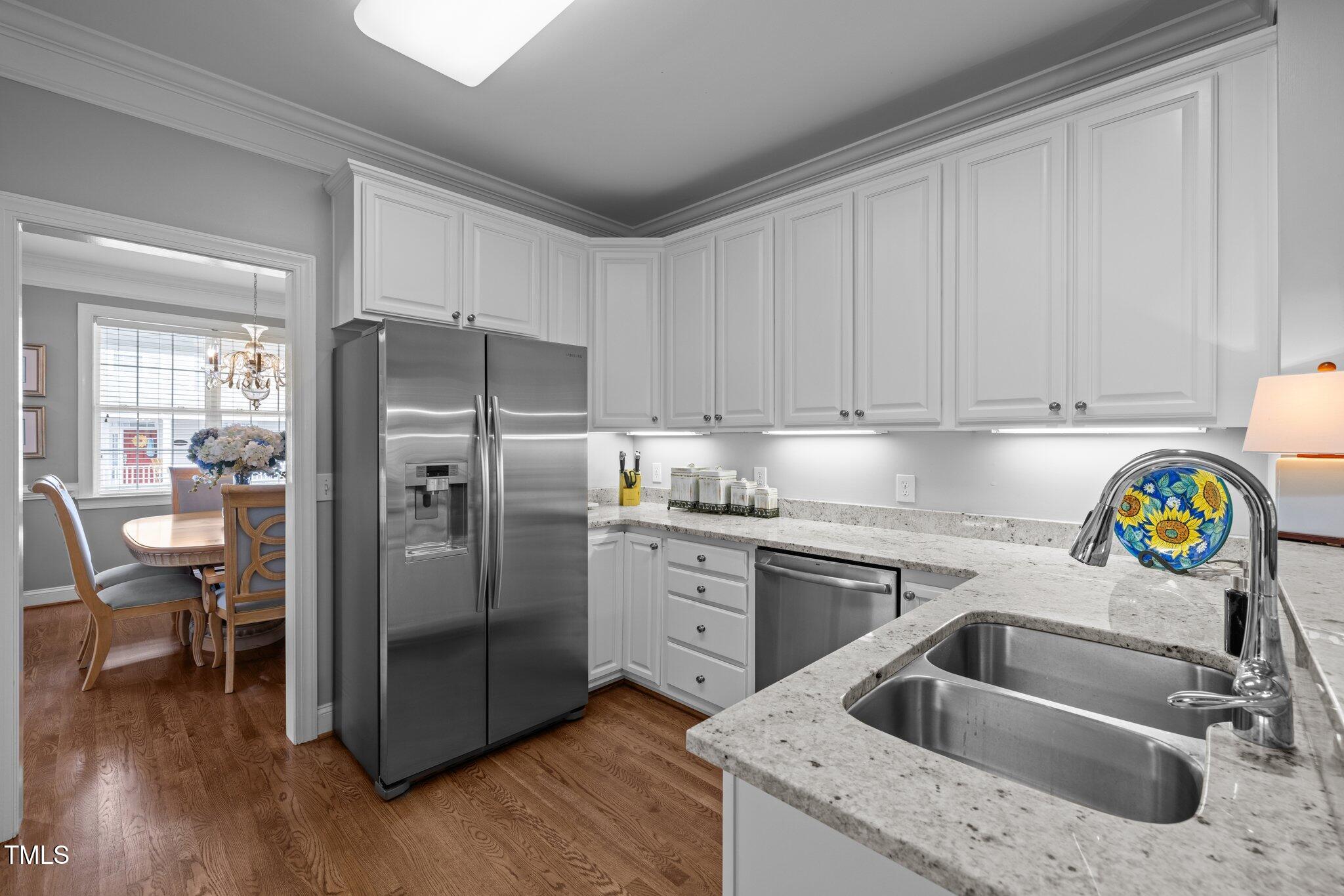 3902 Stags Leap Circle Raleigh, NC 27612 - Photo 12 of 53 a kitchen with a sink cabinets and stainless steel appliances