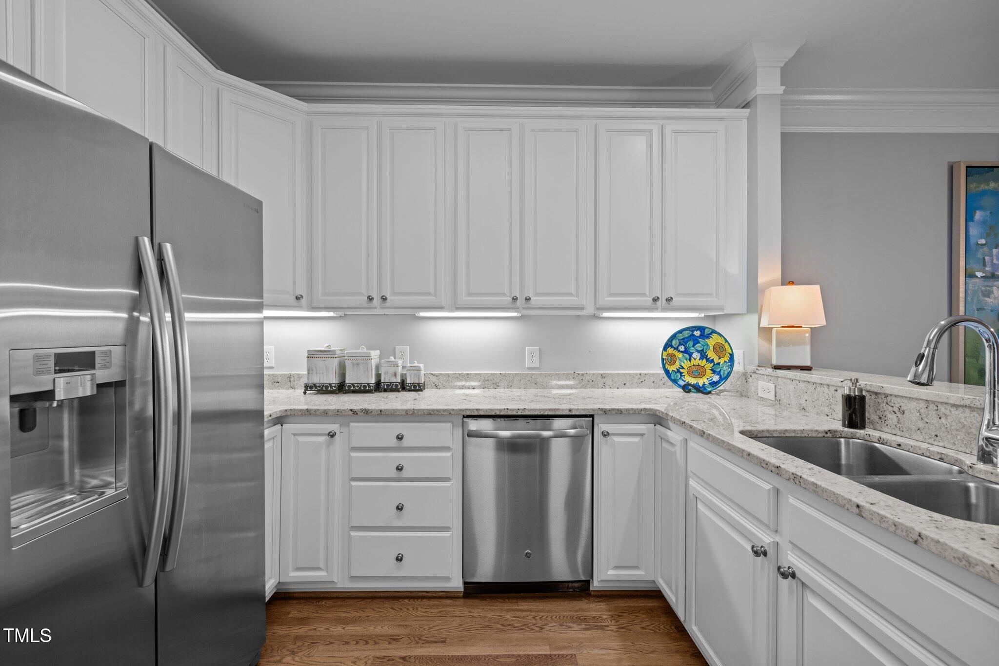 3902 Stags Leap Circle Raleigh, NC 27612 - Photo 13 of 53 a kitchen with stainless steel appliances granite countertop a refrigerator and a sink