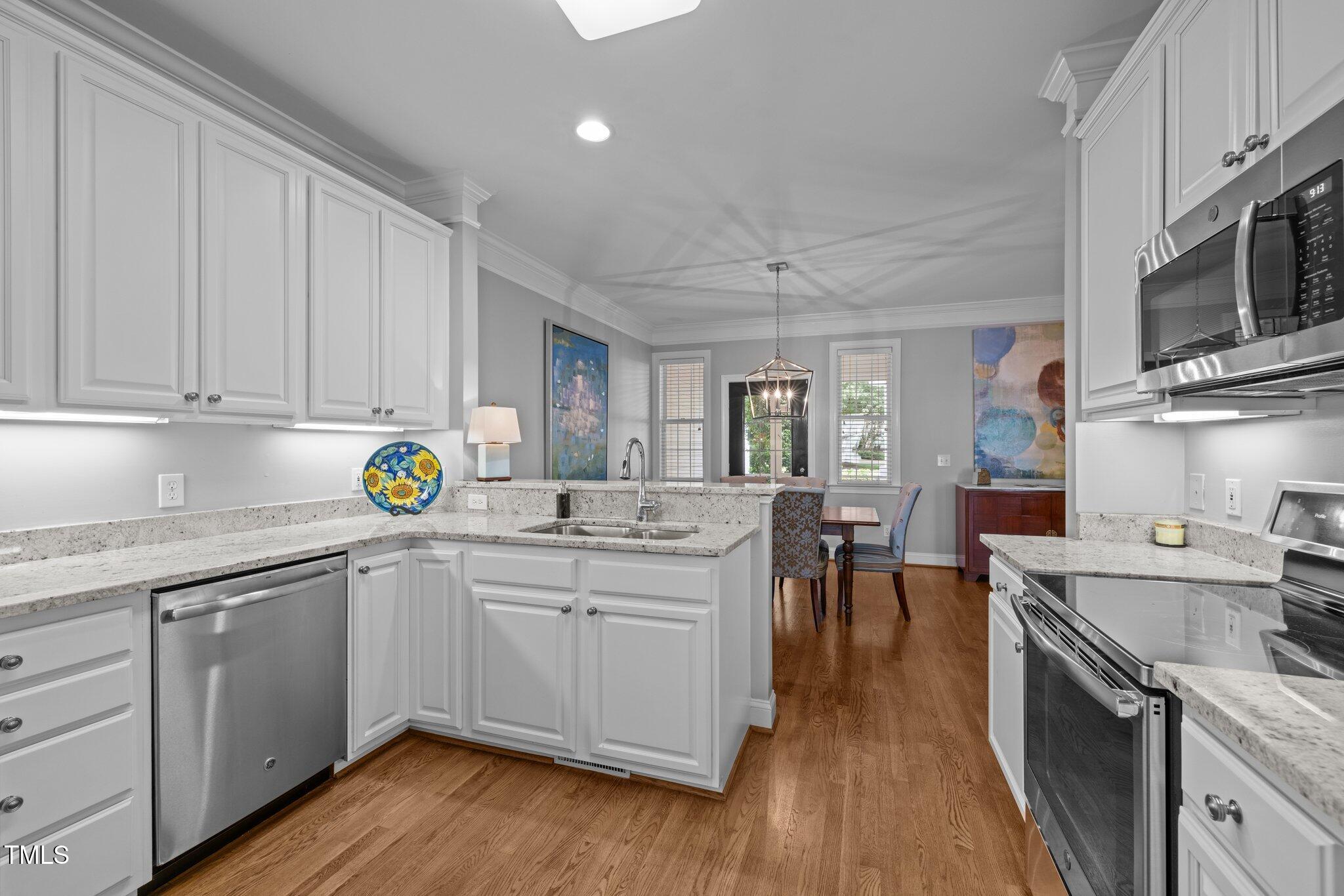 3902 Stags Leap Circle Raleigh, NC 27612 - Photo 14 of 53 a kitchen with a sink cabinets and wooden floor