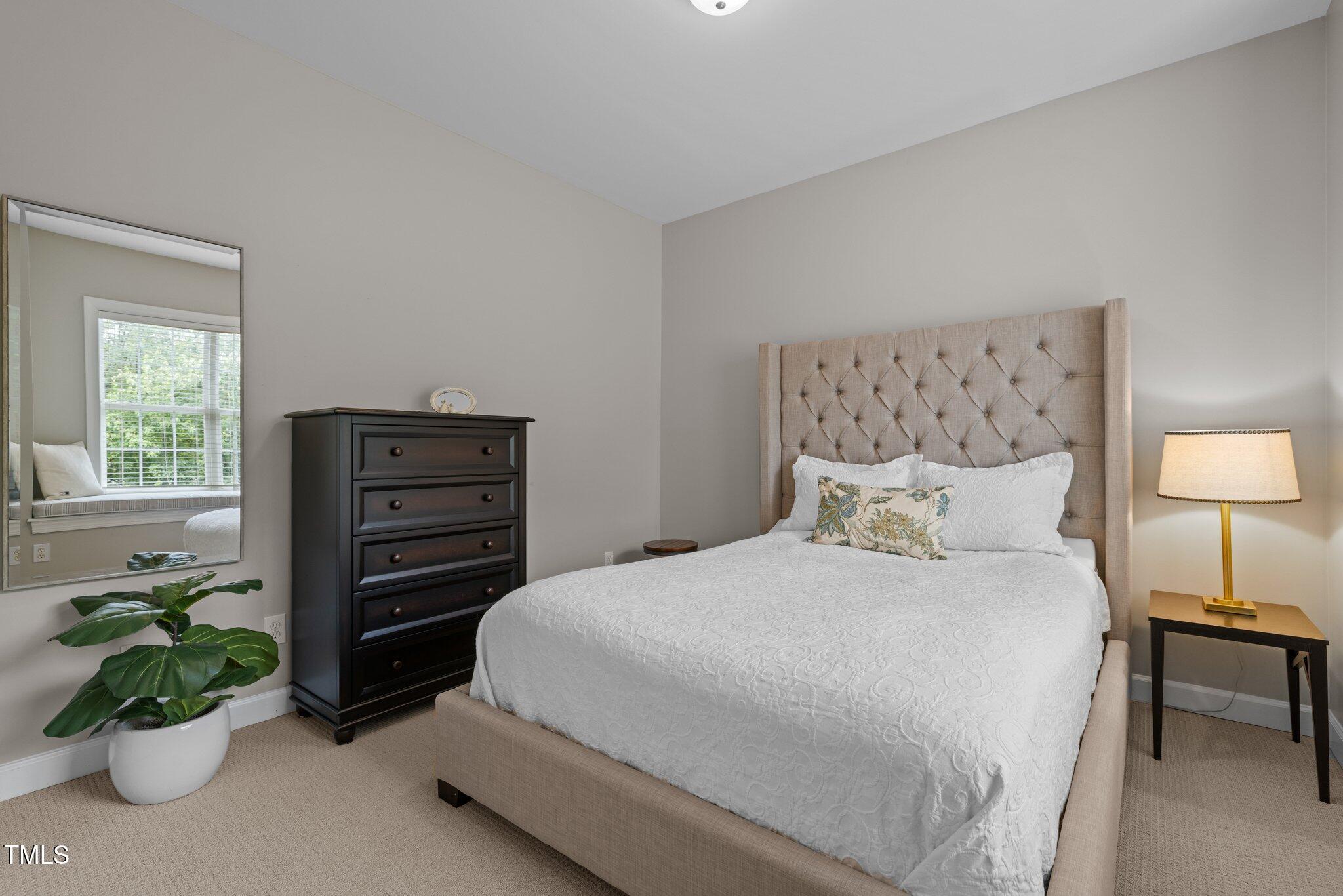 3902 Stags Leap Circle Raleigh, NC 27612 - Photo 26 of 53 a bedroom with a bed and a potted plant