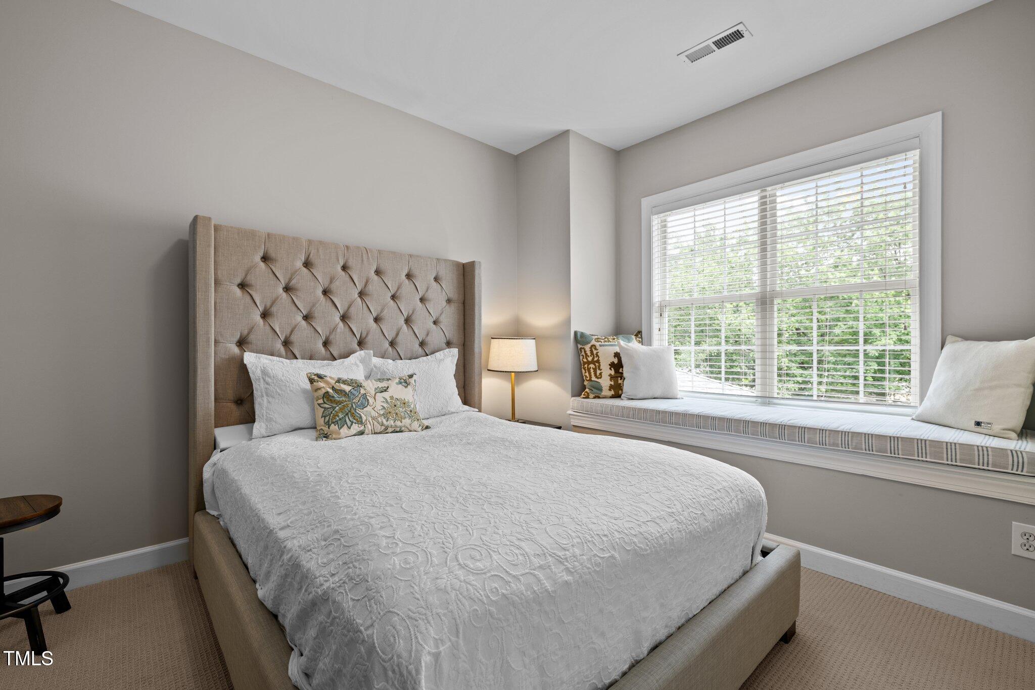 3902 Stags Leap Circle Raleigh, NC 27612 - Photo 27 of 53 a bedroom with a large bed and a window