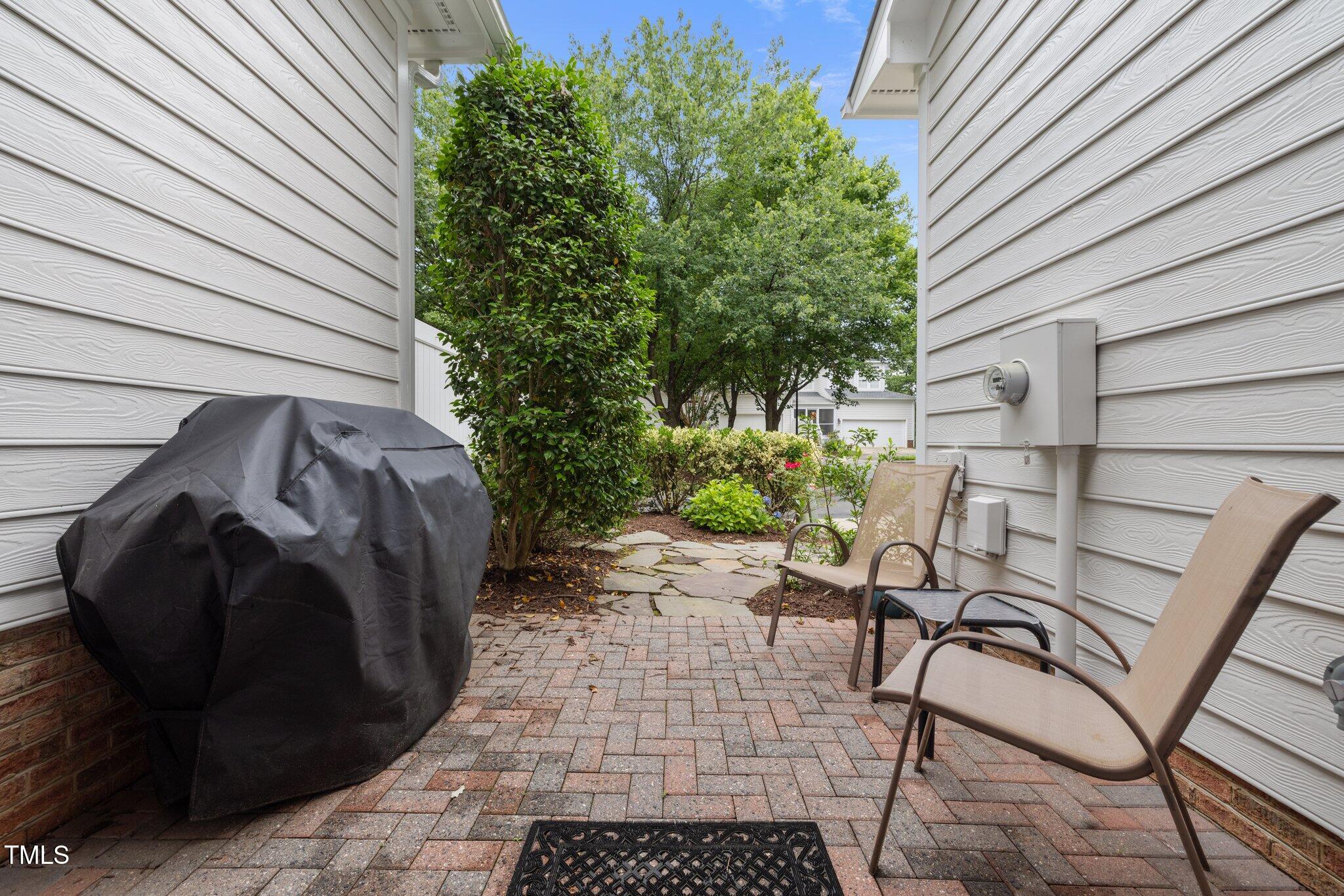 3902 Stags Leap Circle Raleigh, NC 27612 - Photo 39 of 53 a view of a patio with table and chairs and potted plants