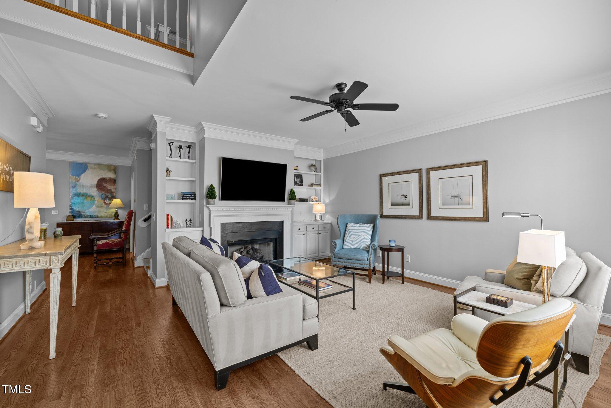 3902 Stags Leap Circle Raleigh, NC 27612 - Photo 6 of 53 a living room with furniture a fireplace and a flat screen tv