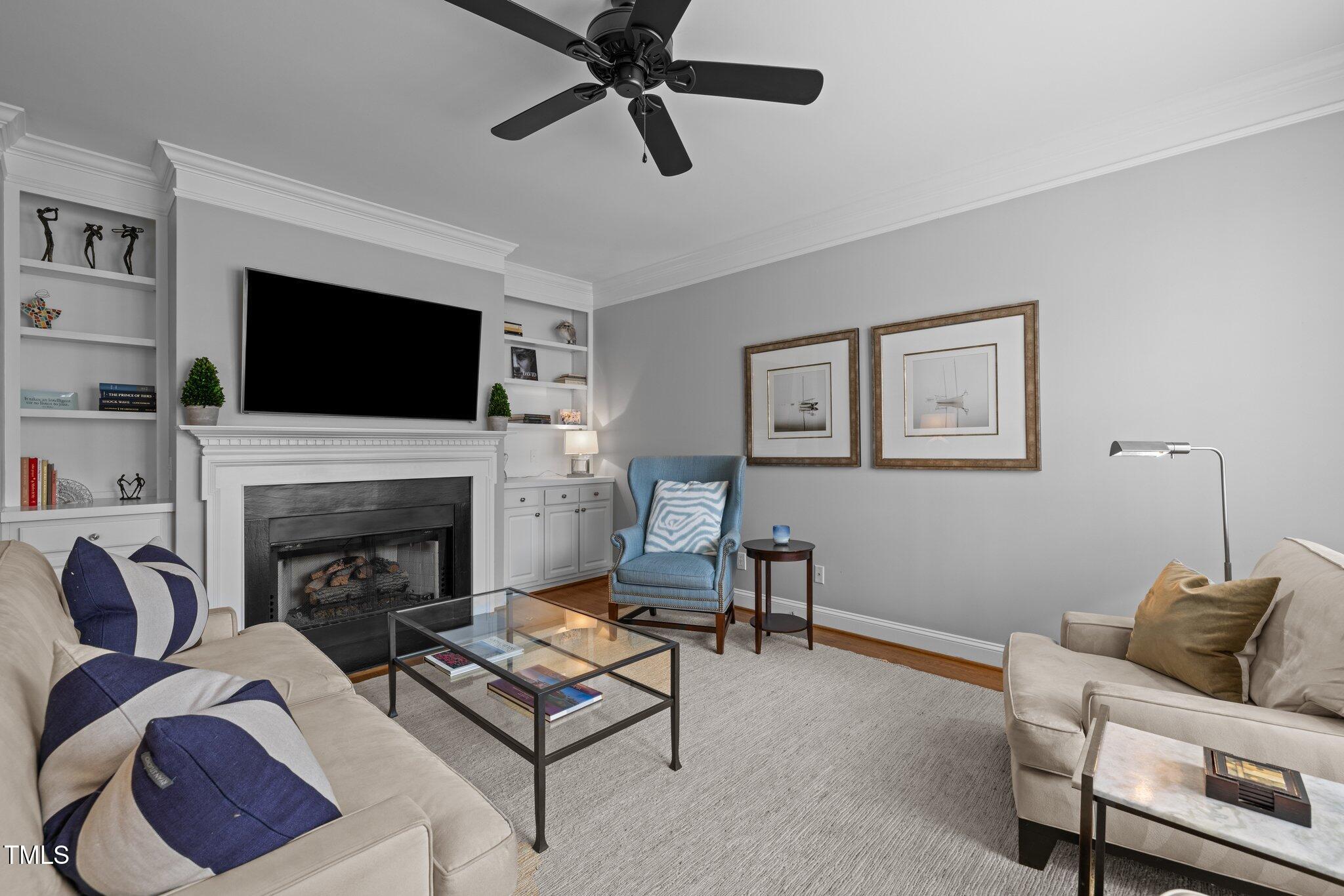 3902 Stags Leap Circle Raleigh, NC 27612 - Photo 7 of 53 a living room with furniture a flat screen tv and a fireplace