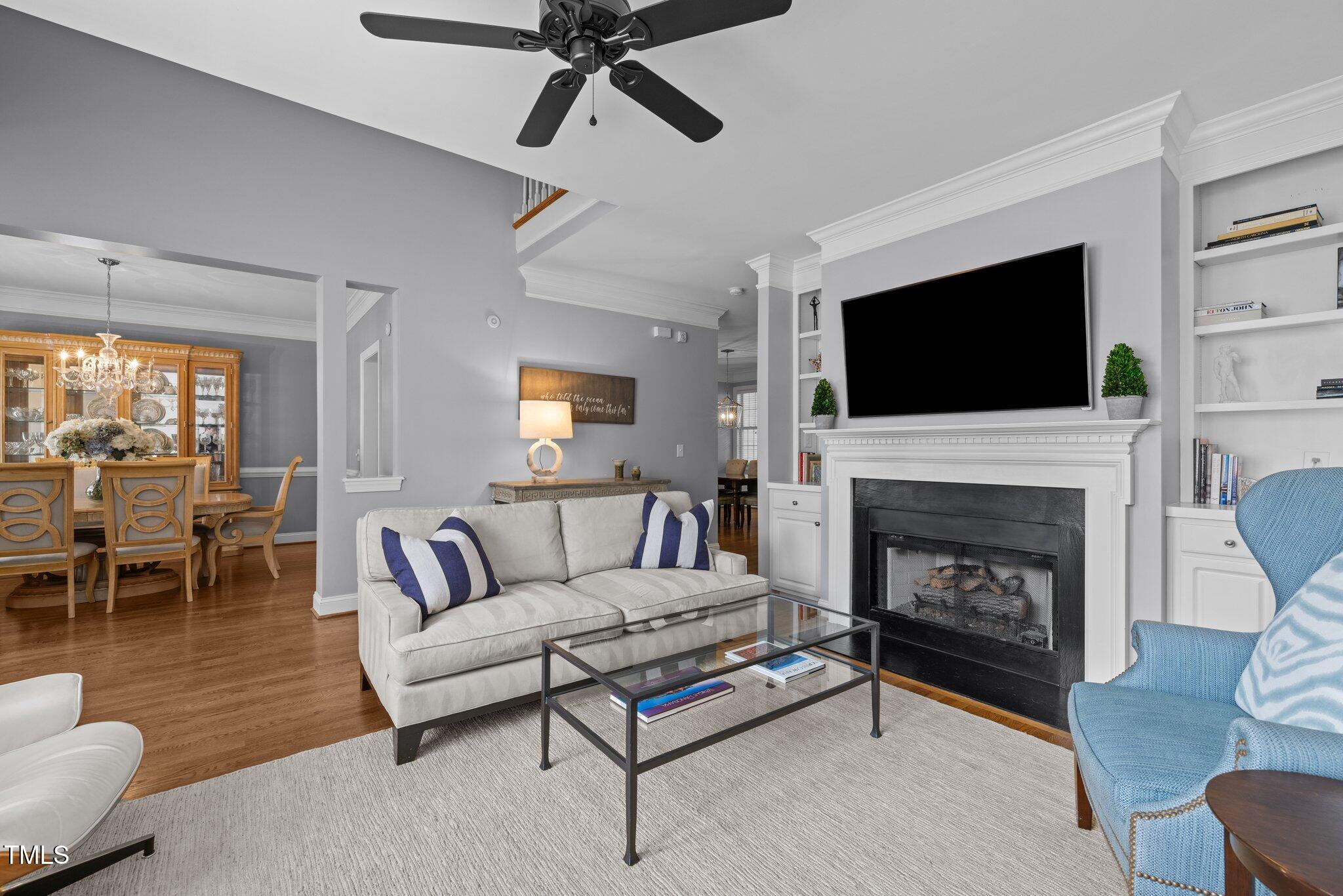 3902 Stags Leap Circle Raleigh, NC 27612 - Photo 8 of 53 a living room with furniture a flat screen tv and a fireplace