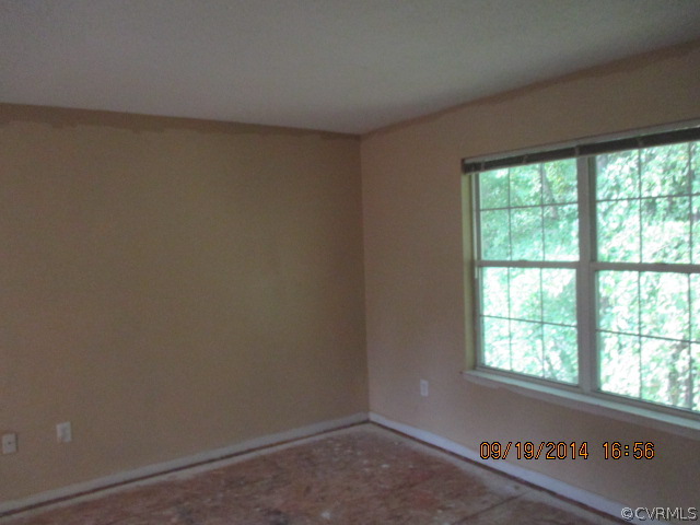 3208 Purvis Road Richmond, VA 23223 - Photo 6 of 10 an empty room with a window