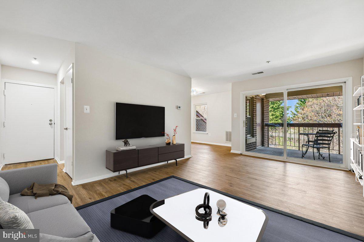 a living room with a flat screen tv and a large window
