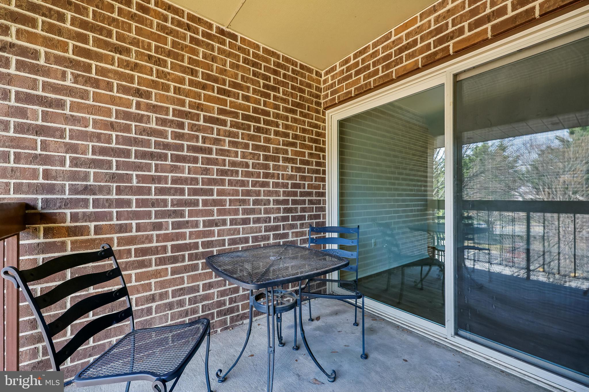 7804 Guildberry Court, Unit 301 Gaithersburg, MD 20879 - Photo 14 of 33 a backyard of a house with table and chairs