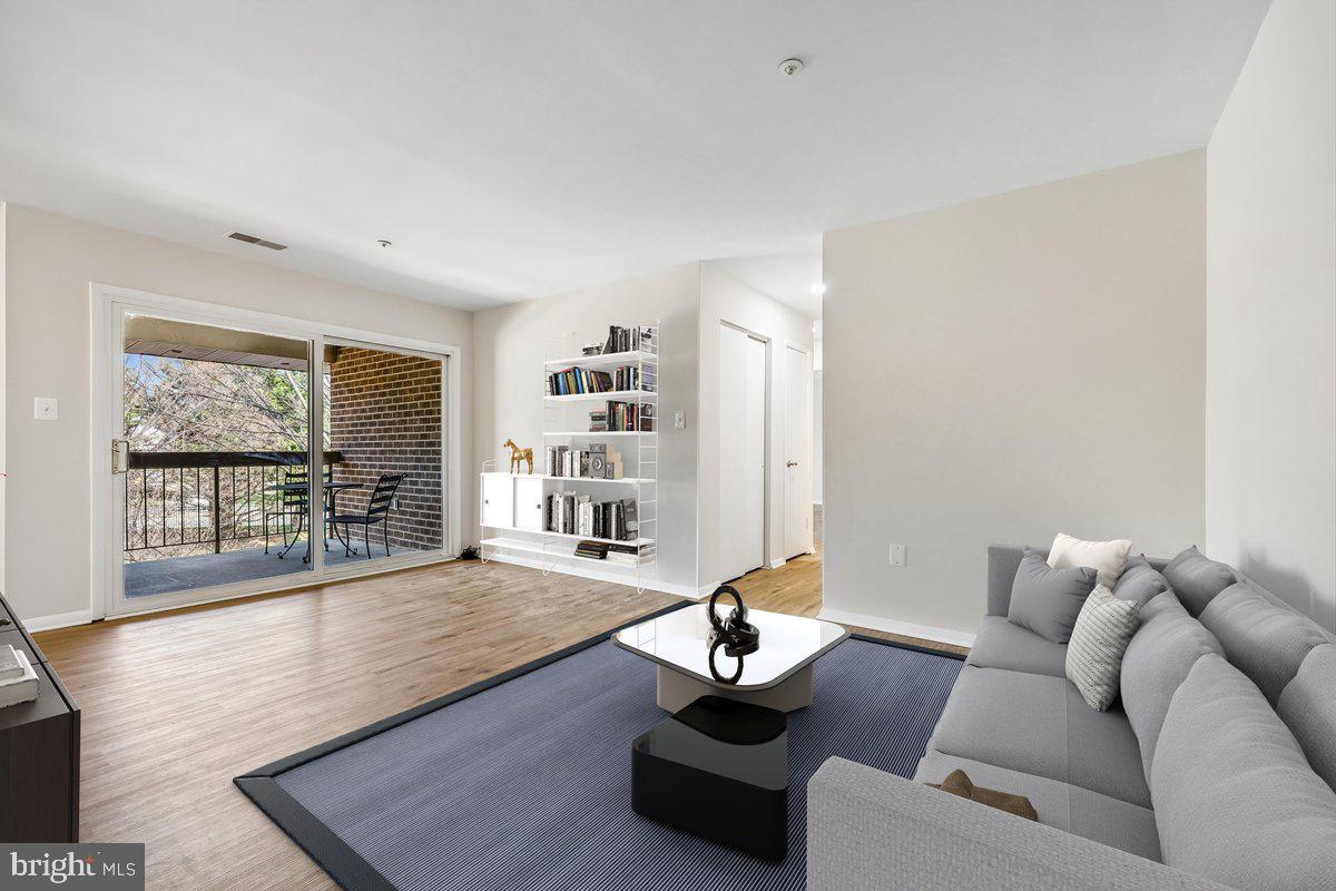 7804 Guildberry Court, Unit 301 Gaithersburg, MD 20879 - Photo 17 of 33 a living room with furniture and a large window