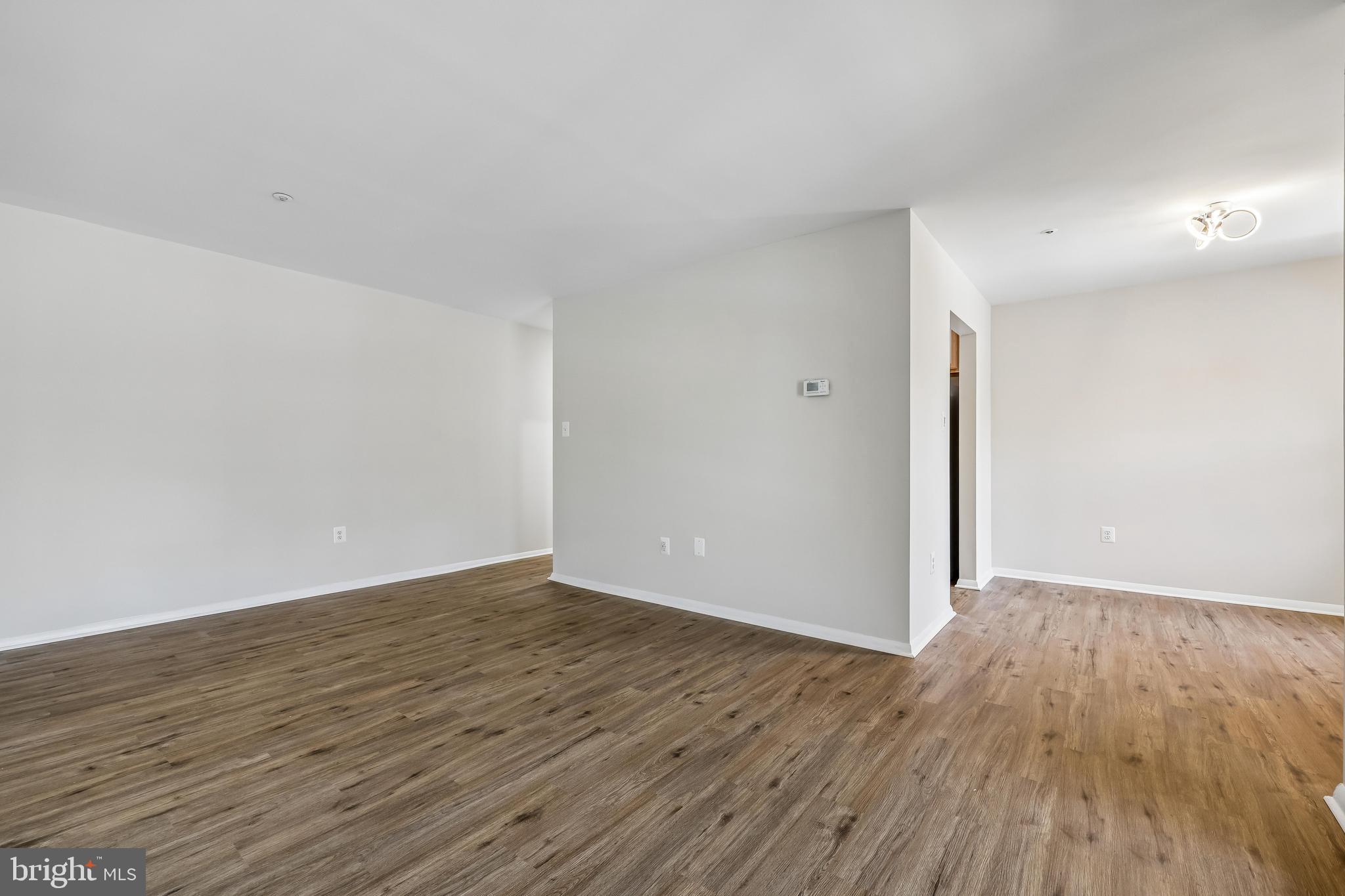 7804 Guildberry Court, Unit 301 Gaithersburg, MD 20879 - Photo 19 of 33 a view of an empty room with wooden floor