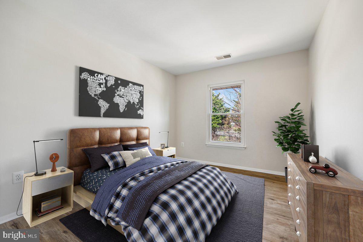 7804 Guildberry Court, Unit 301 Gaithersburg, MD 20879 - Photo 21 of 33 a bedroom with a bed and a window