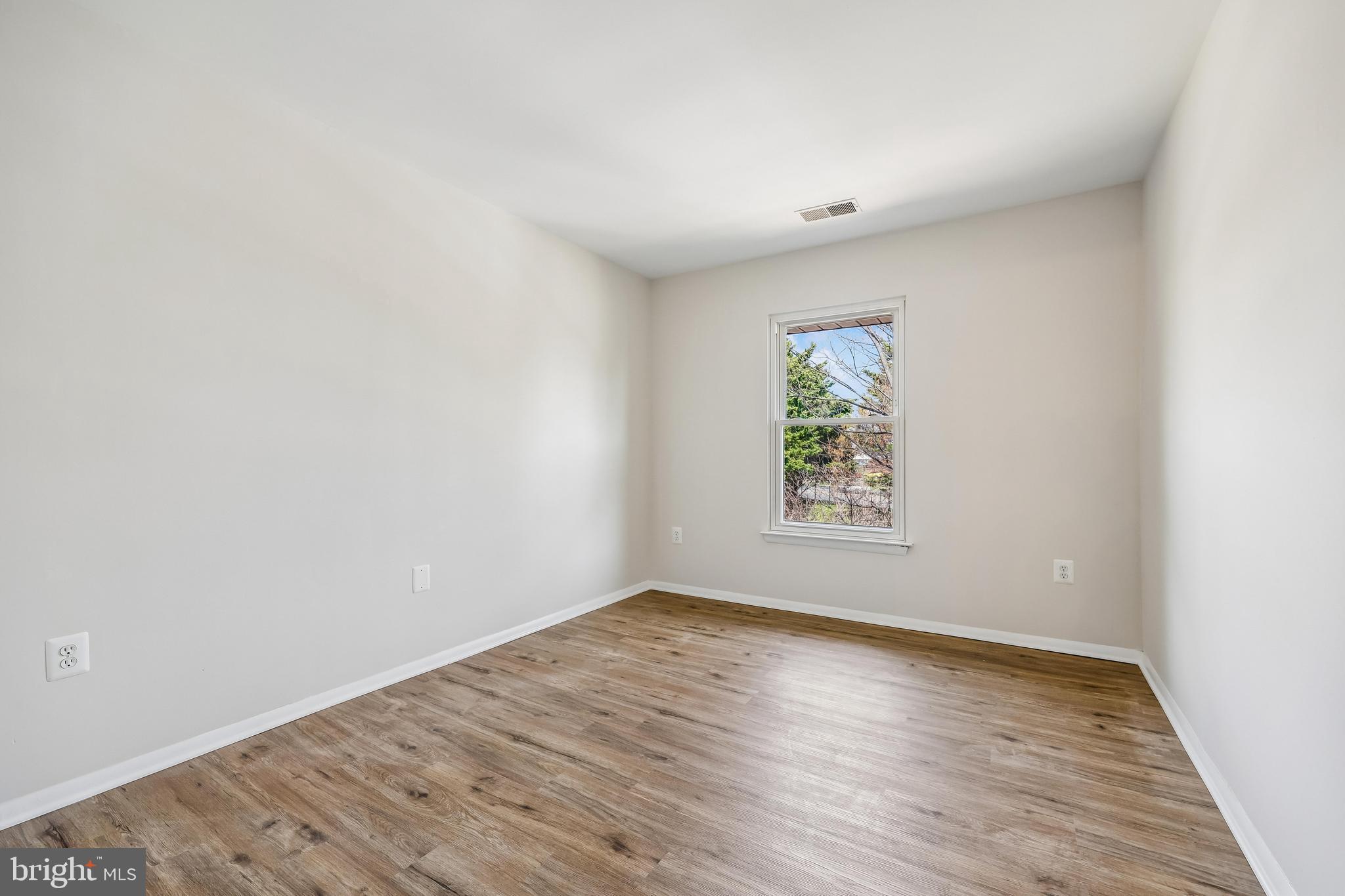 7804 Guildberry Court, Unit 301 Gaithersburg, MD 20879 - Photo 22 of 33 an empty room with wooden floor and window