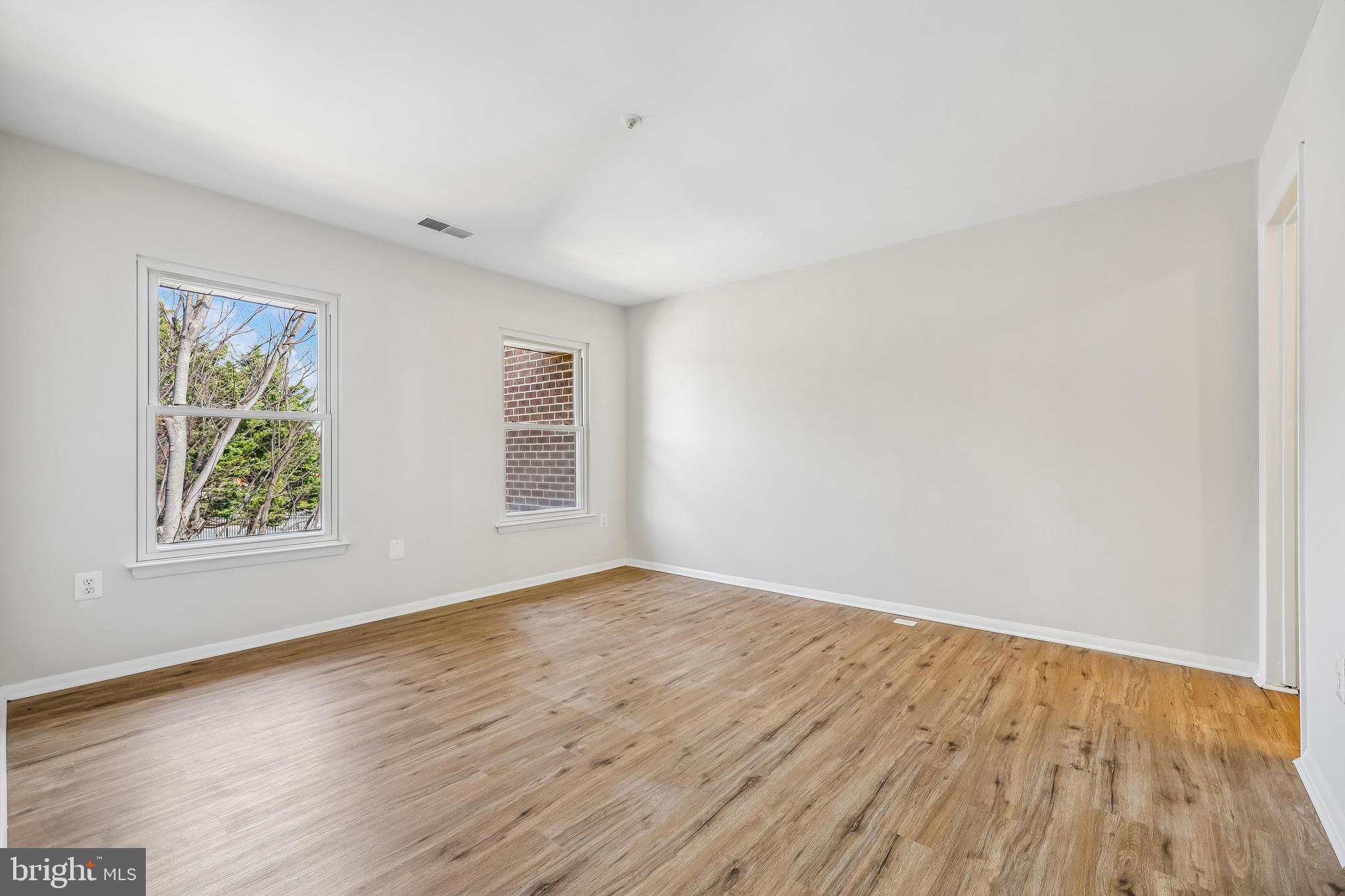 7804 Guildberry Court, Unit 301 Gaithersburg, MD 20879 - Photo 28 of 33 a view of empty room with wooden floor and fan