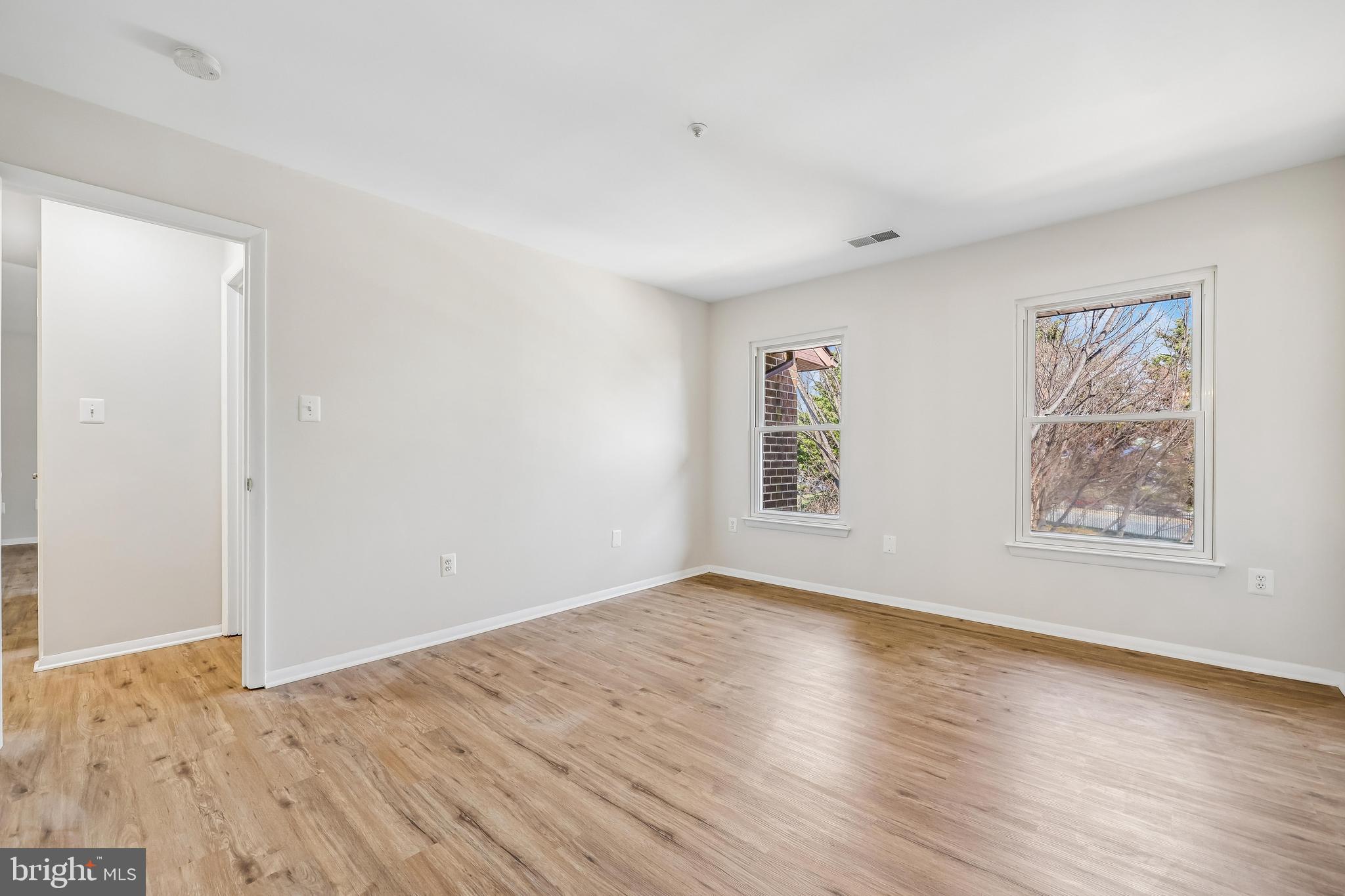 7804 Guildberry Court, Unit 301 Gaithersburg, MD 20879 - Photo 29 of 33 a view of empty room with wooden floor and fan