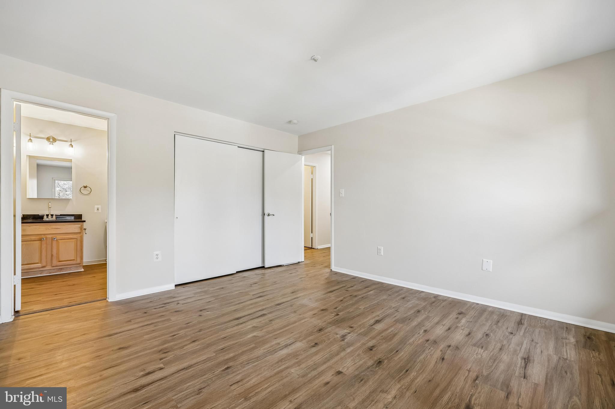 7804 Guildberry Court, Unit 301 Gaithersburg, MD 20879 - Photo 30 of 33 a view of an empty room with wooden floor