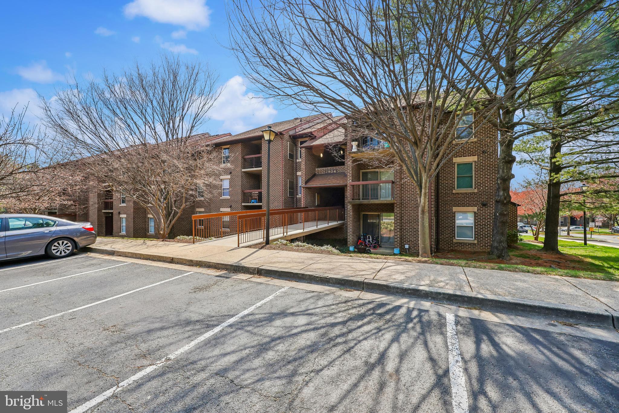7804 Guildberry Court, Unit 301 Gaithersburg, MD 20879 - Photo 32 of 33 a front view of a house with a yard and garage