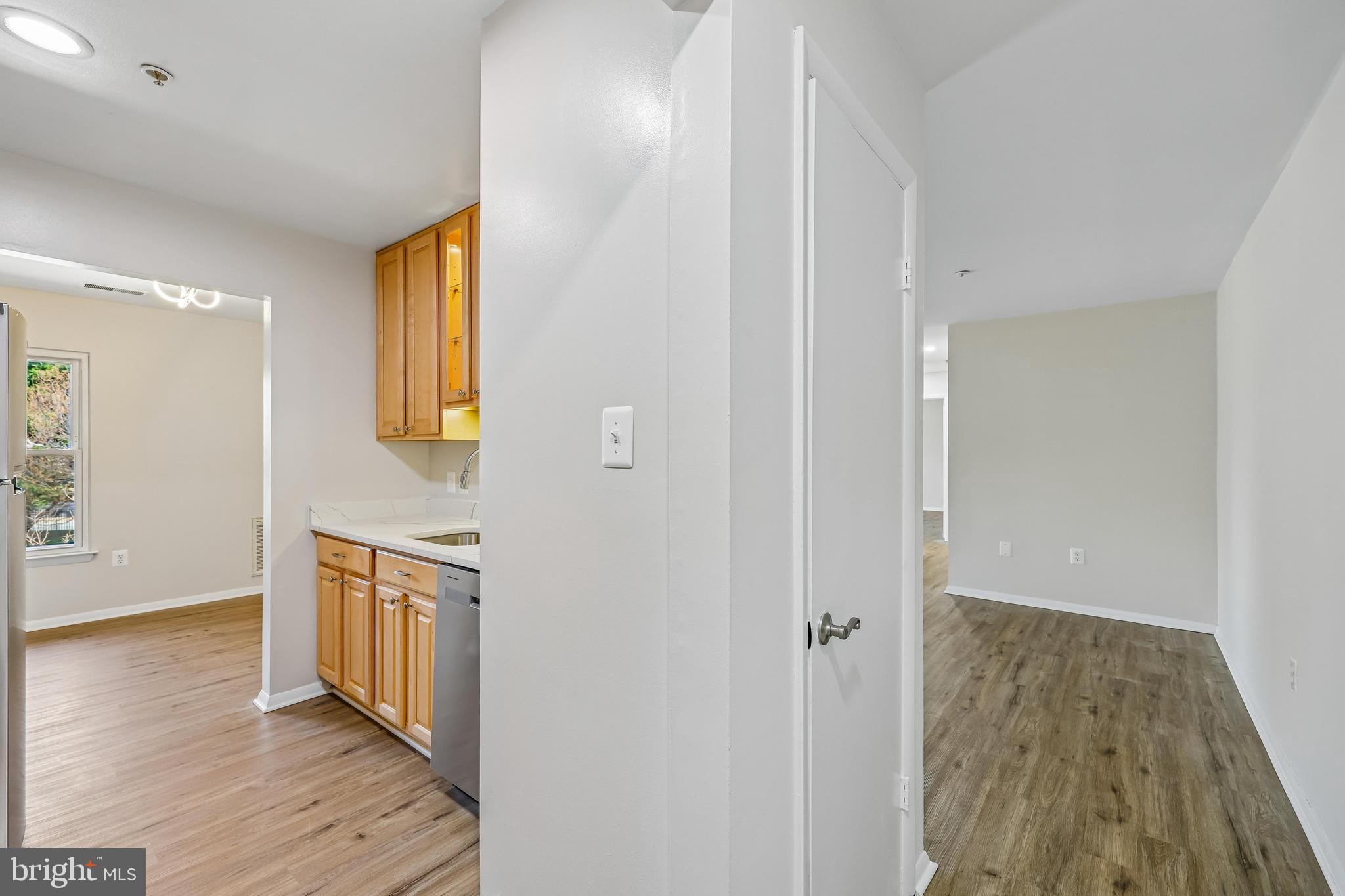 7804 Guildberry Court, Unit 301 Gaithersburg, MD 20879 - Photo 5 of 33 a view of a kitchen from the hallway