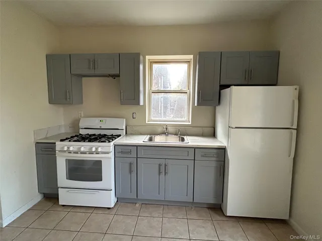 a kitchen with a stove top oven and refrigerator