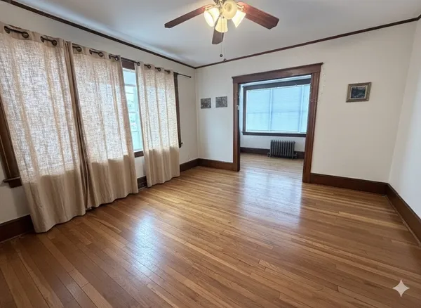 wooden floor in an empty room with a window