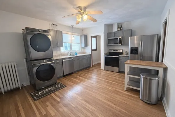 a kitchen with stainless steel appliances a stove a sink and a refrigerator