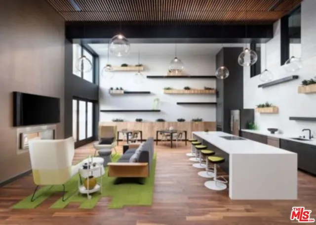 a dining room with granite countertop lots of wooden furniture and wooden floor
