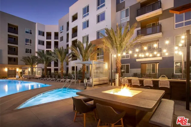 a swimming pool view with outdoor seating