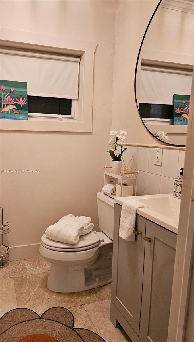 131 Zamora Avenue, Unit 2 Coral Gables, FL 33134 - Photo 14 of 17 a bathroom with a sink toilet and mirror