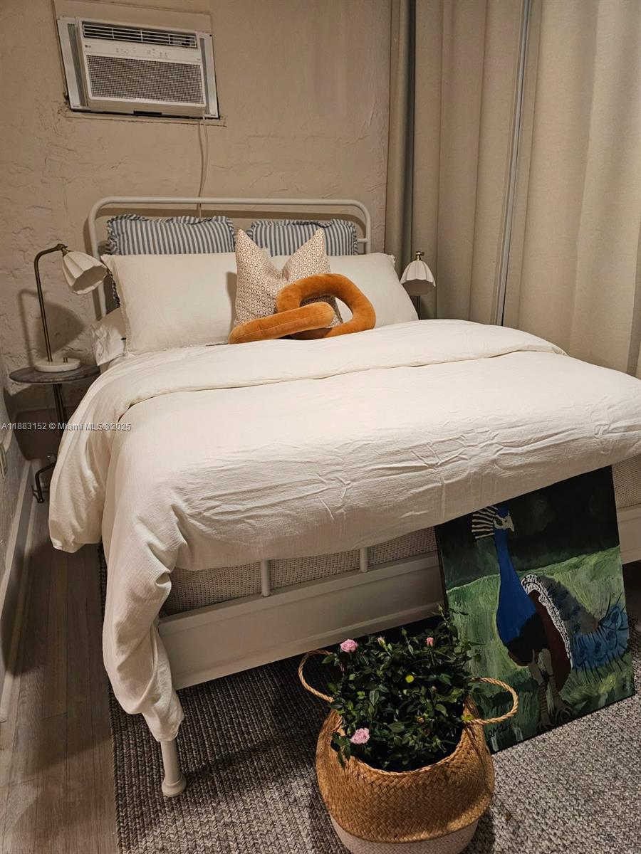 131 Zamora Avenue, Unit 2 Coral Gables, FL 33134 - Photo 6 of 17 a bedroom with a bed and a chair