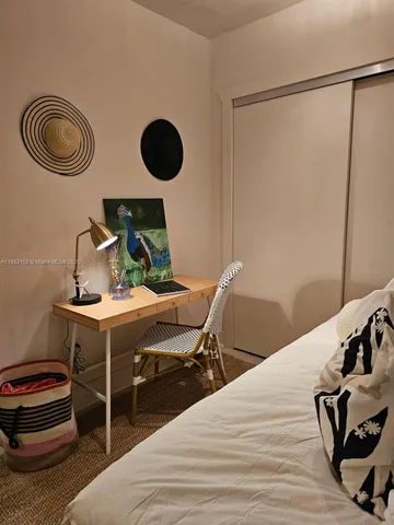 a bedroom with a bed and a painting on the wall