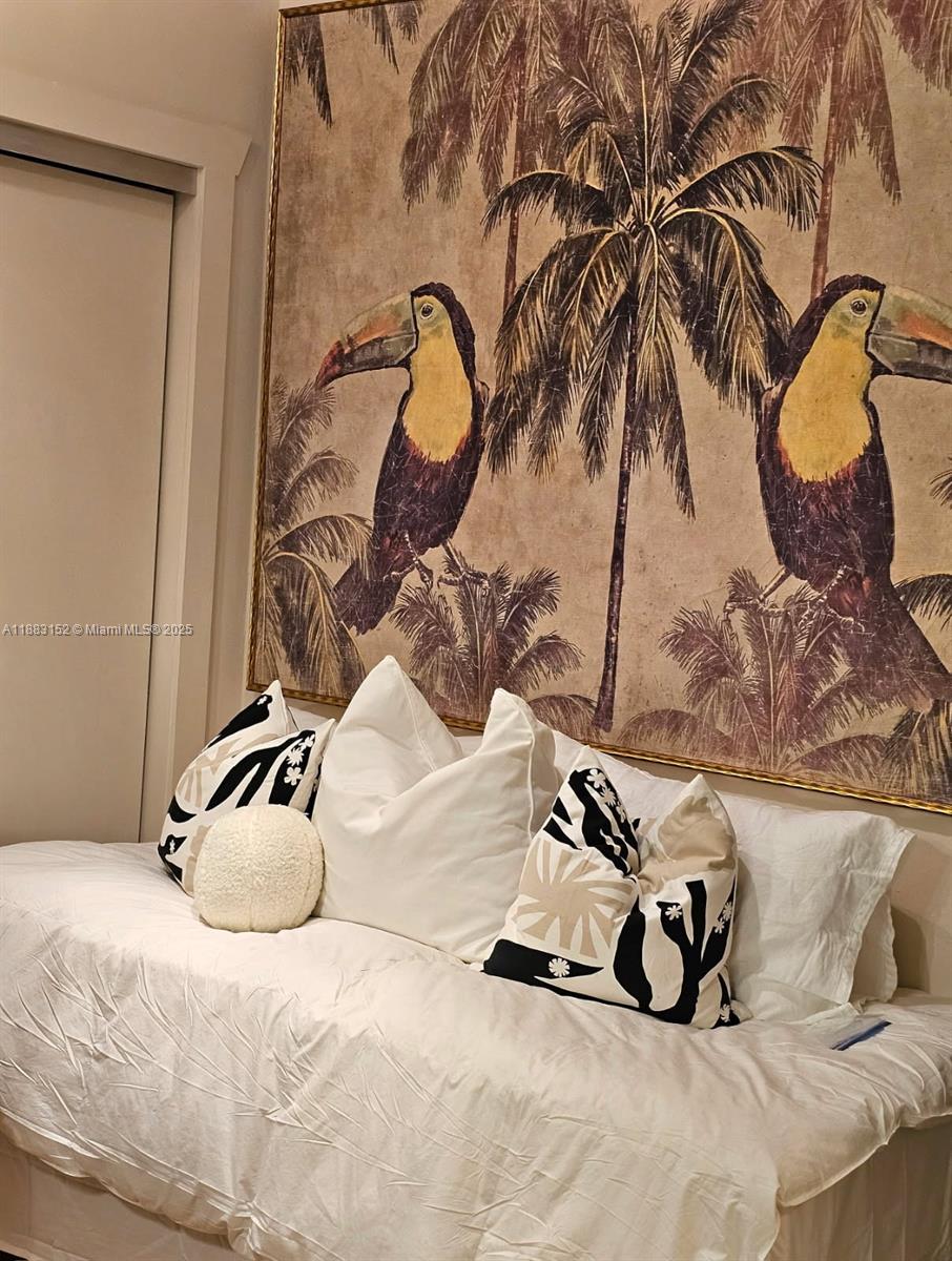 131 Zamora Avenue, Unit 2 Coral Gables, FL 33134 - Photo 8 of 17 a bedroom with a bed and a painting on the wall