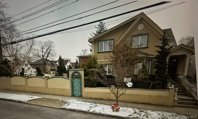 a front view of a house with a yard and trees
