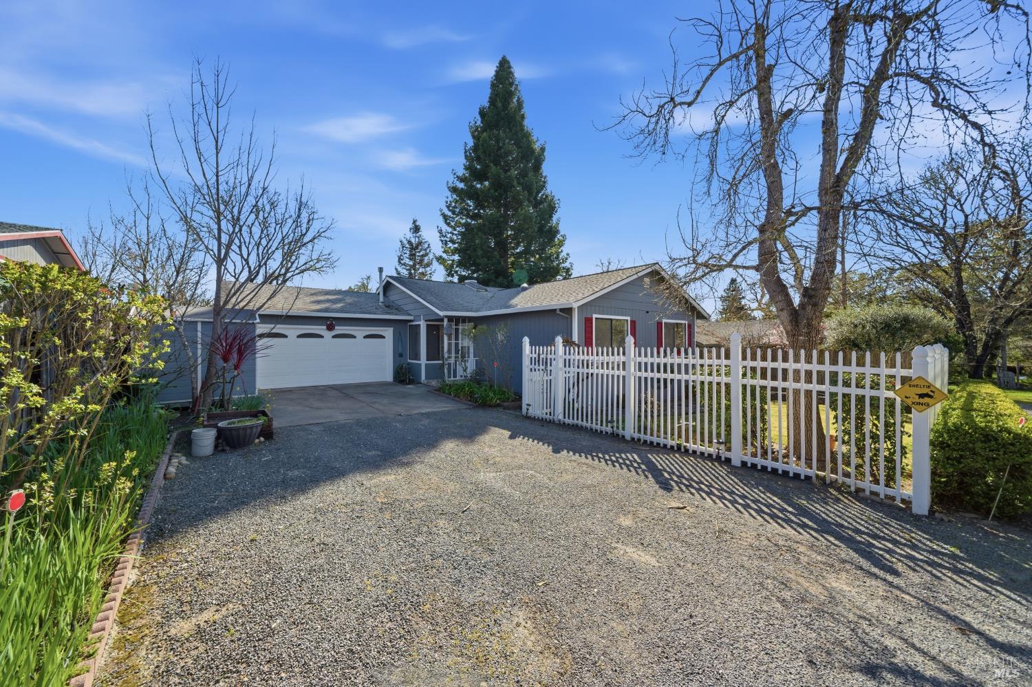 a view of a house with a yard and wooden fence