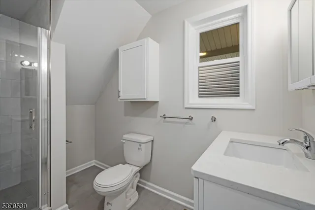 a white toilet sitting next to a bathroom sink