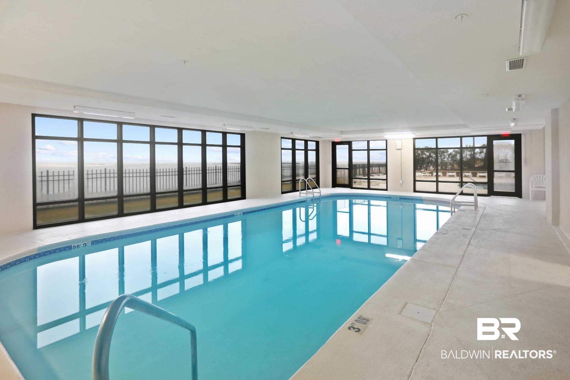 27284 Gulf Road, Unit 611 Orange Beach, AL 36561 - Photo 9 of 11 Indoor community pool with a sunroom
