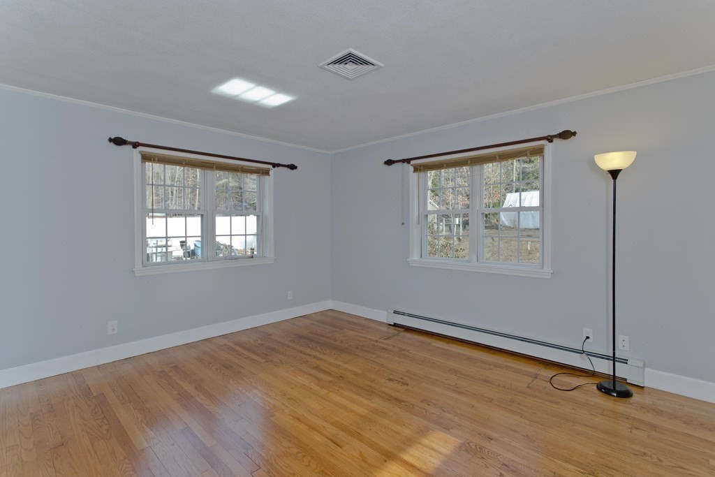 146 Huntington Road Russell, MA 01071 - Photo 20 of 42 a view of empty room with wooden floor and fan