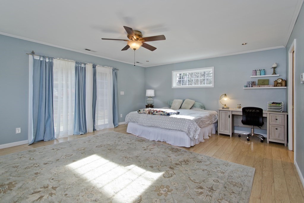 146 Huntington Road Russell, MA 01071 - Photo 26 of 42 a spacious bedroom with a bed and a chandelier