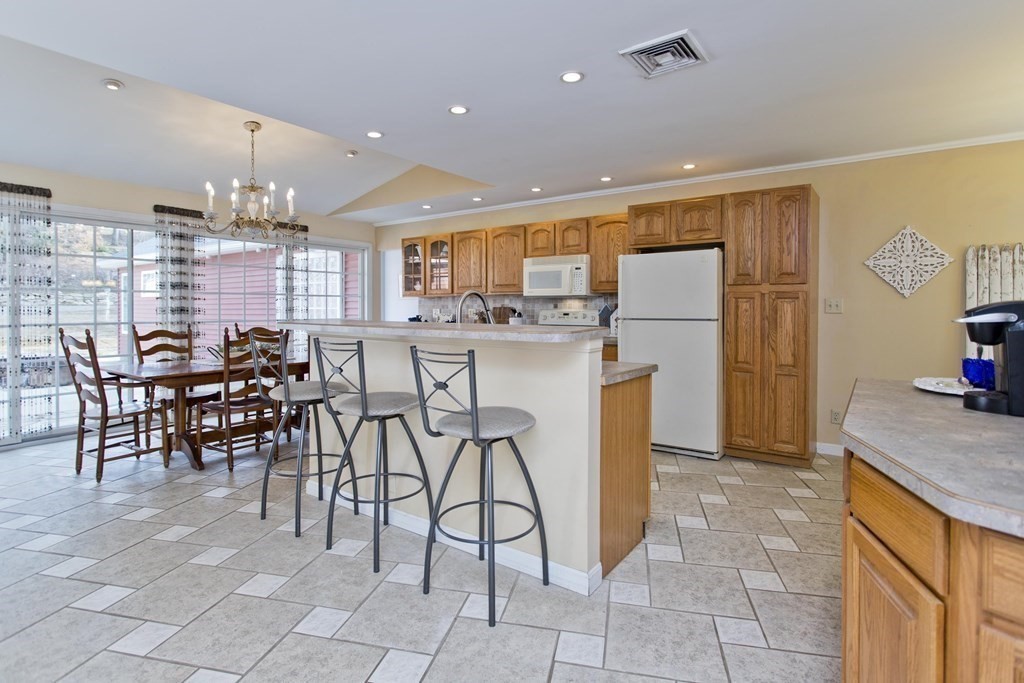 146 Huntington Road Russell, MA 01071 - Photo 3 of 42 a kitchen with stainless steel appliances granite countertop a table and chairs in it