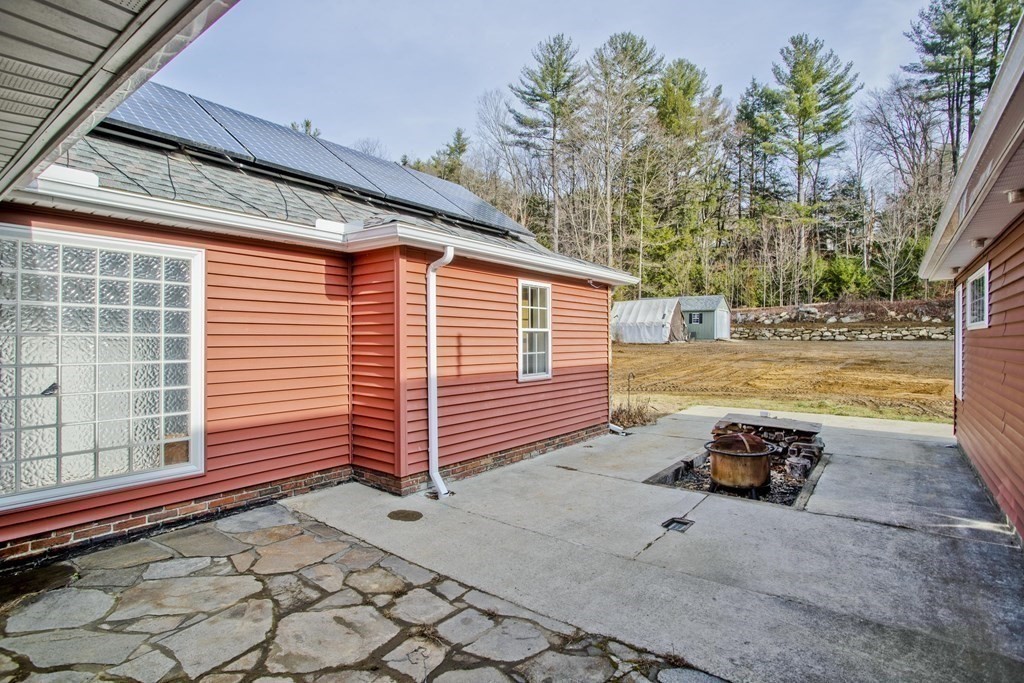 146 Huntington Road Russell, MA 01071 - Photo 39 of 42 a backyard of a house with barbeque oven table and chairs