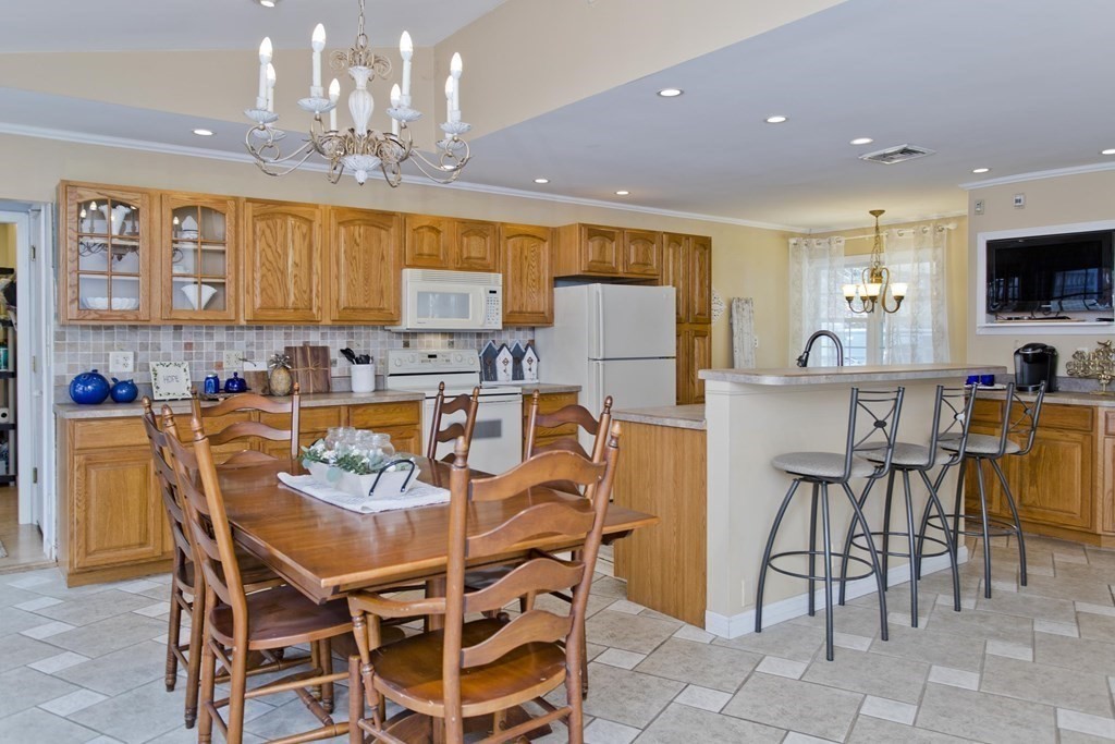 146 Huntington Road Russell, MA 01071 - Photo 5 of 42 a dining table with chairs and kitchen view