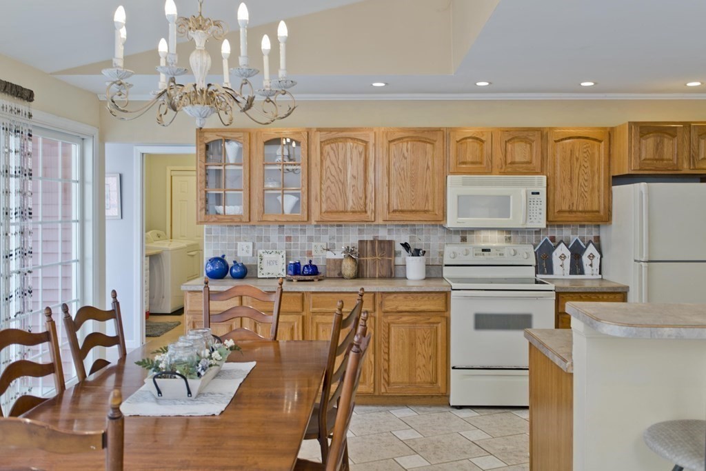 146 Huntington Road Russell, MA 01071 - Photo 6 of 42 a kitchen with stainless steel appliances granite countertop a refrigerator a sink dishwasher and white cabinets with wooden floor