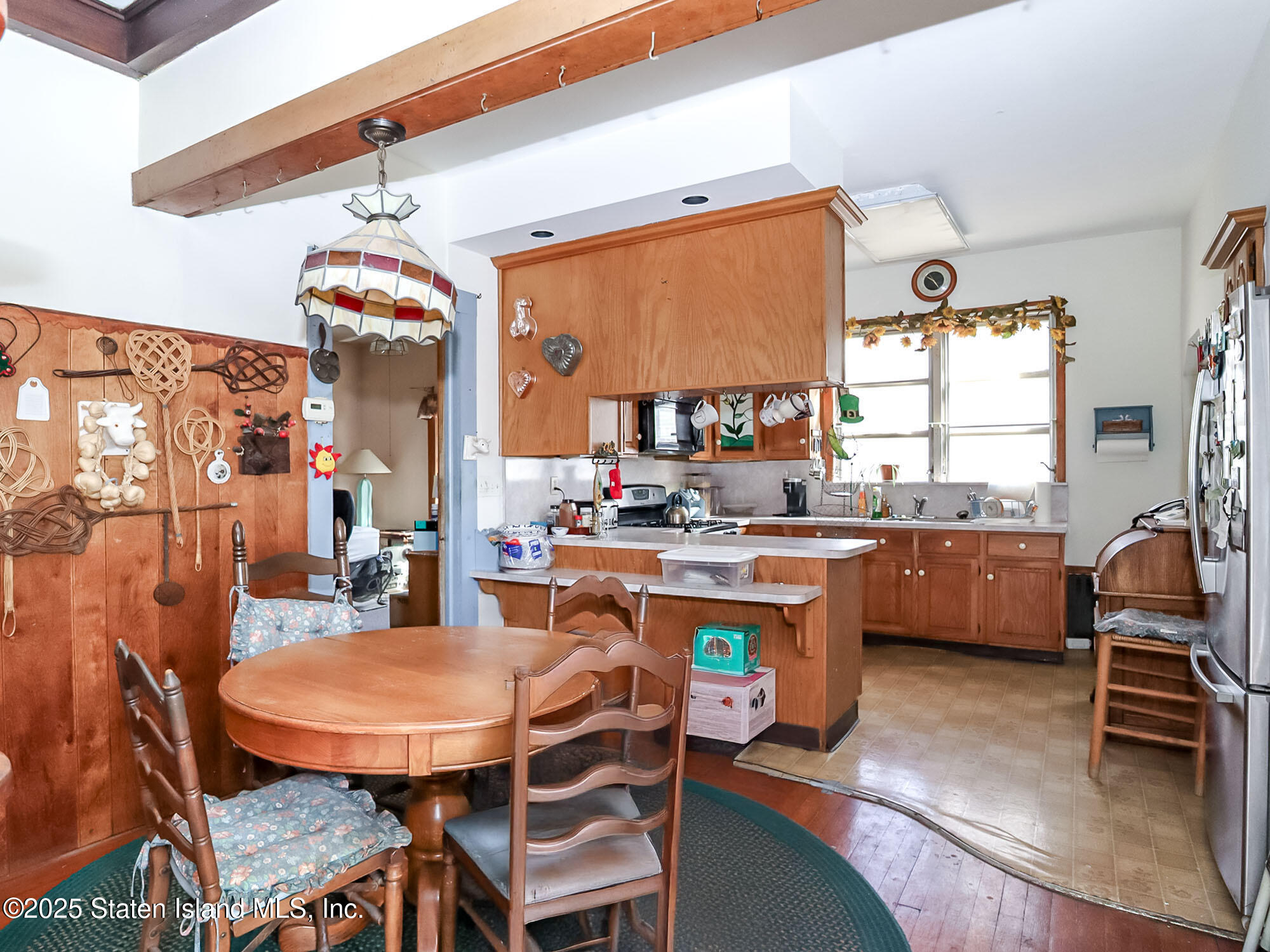 151 Clinton B Fiske Avenue Staten Island, NY 10314 - Photo 11 of 33 a dining room with a table and chairs