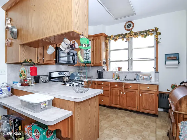 a kitchen with a sink cabinets and window