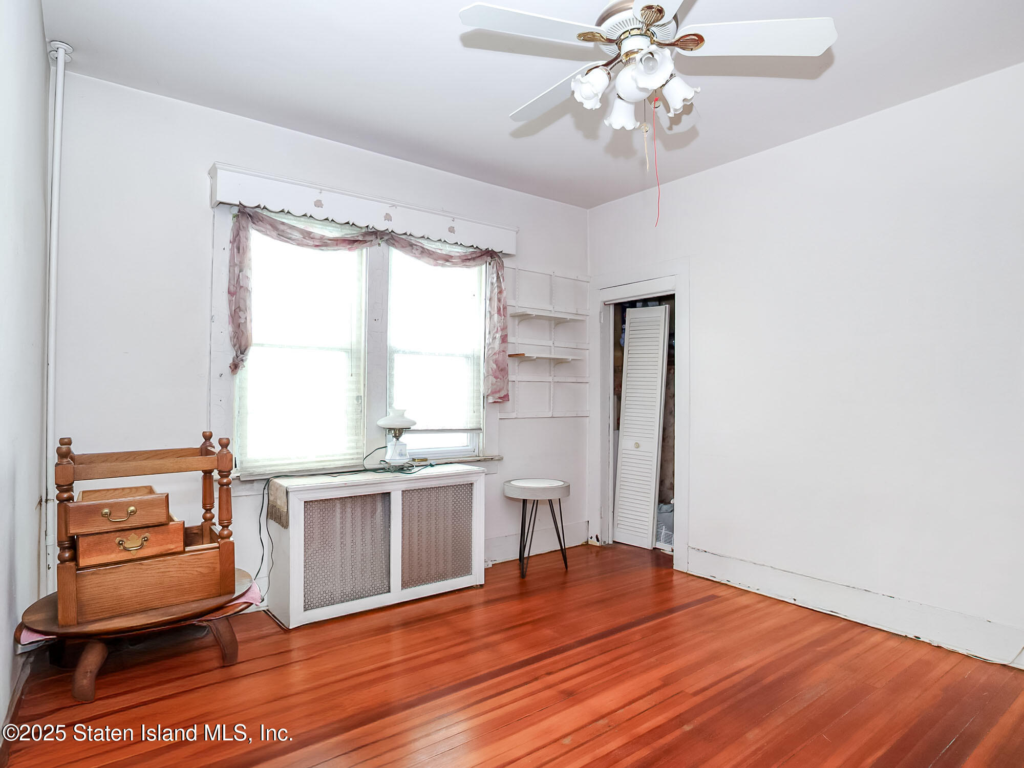 151 Clinton B Fiske Avenue Staten Island, NY 10314 - Photo 18 of 33 a view of a room with wooden floor and cabinet